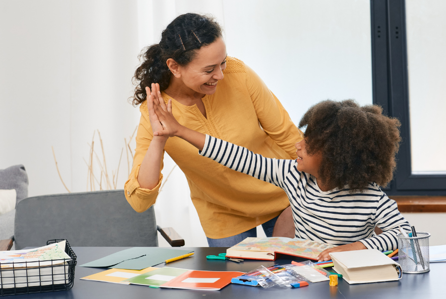 Lady and child high fiving